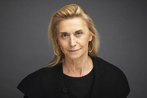 Sylvia's headshot. She has shoulder length blonde hair and is wearing all black.